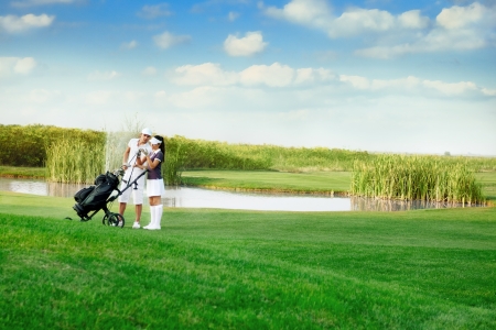 
Young sporty couple playing golf on a golf courseの写真素材