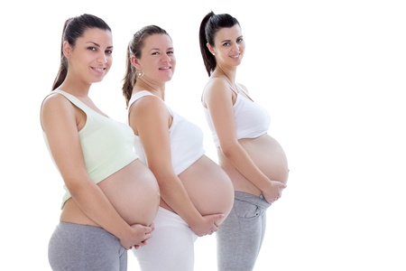 Young pregnant women in third trimester smiling and looking at camera
