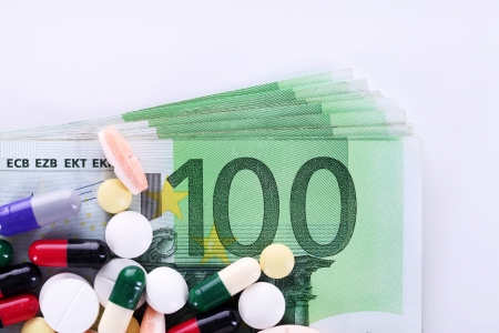 Pills of different colors on money backgroundの写真素材