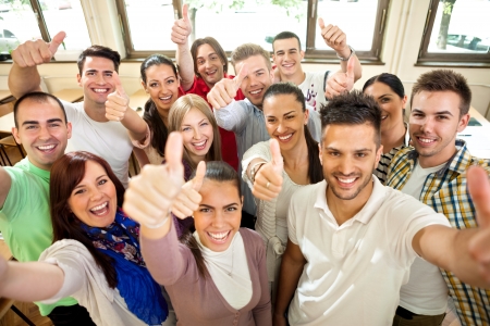 Group of happiness students with raised hands