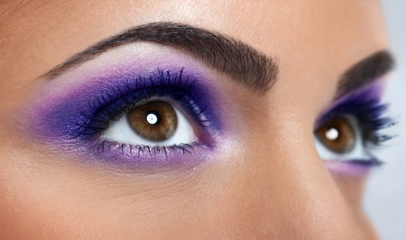 closeup of beautiful eyes with purple makeupの写真素材