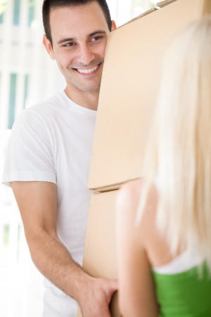 smiling man moving in new home  in with girlfriendの写真素材