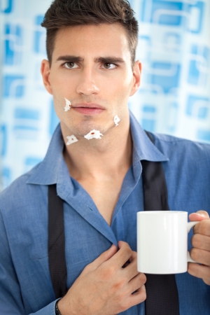 Young man looking his injury face with multiple cuts  in mirrorの写真素材