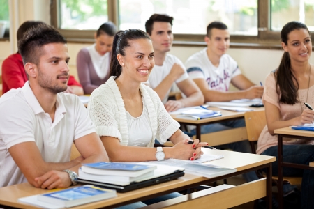 
young students in classroom listening a lecturerの写真素材