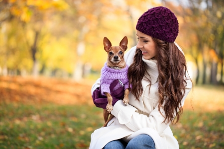 
beautiful woman and his dog in autumn parkの写真素材