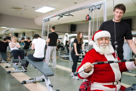 Santa Claus  doing exercises at a gymの写真素材