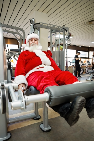 Father Christmas doing exercises before delivering presentsの写真素材