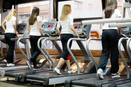 young women in the gym center, running on treadmillの写真素材