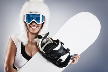 
Beautiful young female snowboarder with white fur hat の写真素材