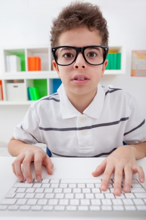 young boy playing a computer gameの写真素材
