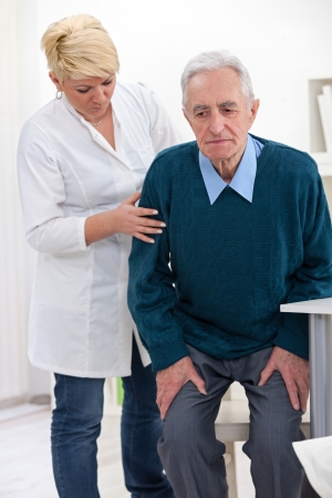 
cheerful nurse helps senior manの写真素材