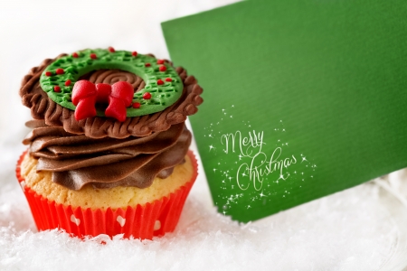 
Christmas cupcake with blank card in snowの写真素材