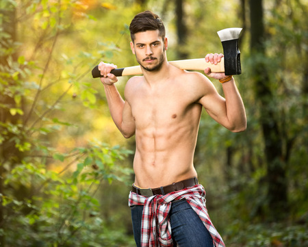 
Sexy lumberjack in forest, shirtless manual workerの写真素材