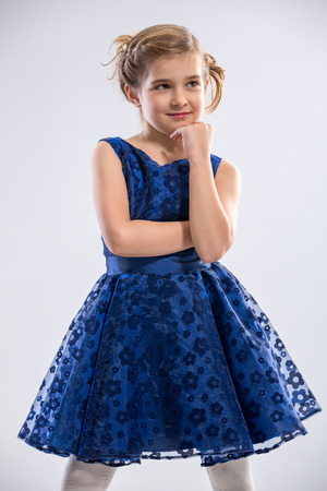Cute girl posing in  wearing  blue dressの写真素材