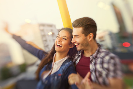 
Happy young couple riding in the amusement park  - shoot with lensbabyの写真素材