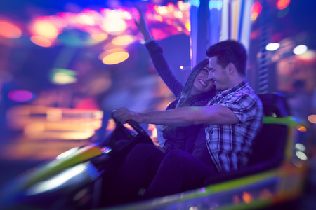  Young couple having fun in bumper car