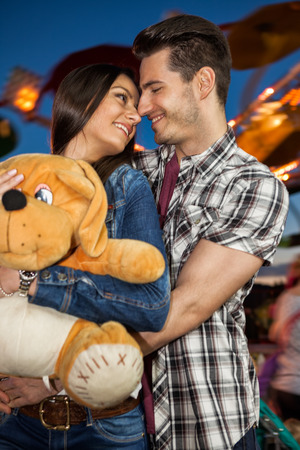 
Affectionate couple smiling and looking at each other at amusement parkの写真素材