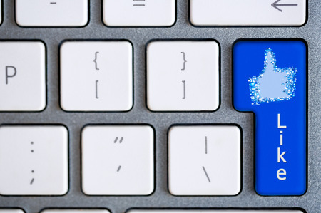 Social media concept: Enter button with Like on computer keyboard backgroundの写真素材