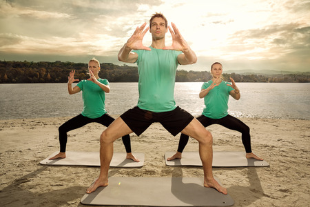 Group of young people having yoga class, outdoorの写真素材