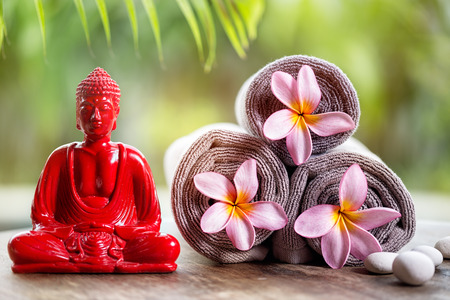 Buddha and flower in towels, wellness backgroundの写真素材