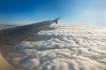 Wing of airplane from window with beautiful sky