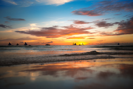 Tropical beach at beautiful colorful sunsetの写真素材