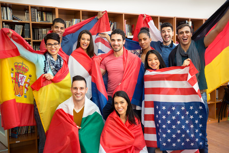 International multiethnic exchange of students, happy students presenting their countries with flagsの写真素材