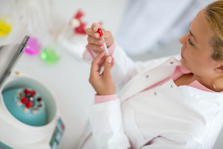 Close up of attractive female looking test tube with simpleの写真素材