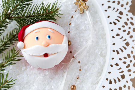 cupcake with Santa Claus face over decorative backgroundの写真素材
