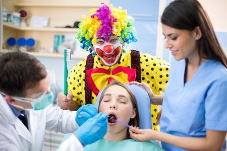 Colorful clown teach - who don't use toothbrush ends in dental clinicの写真素材