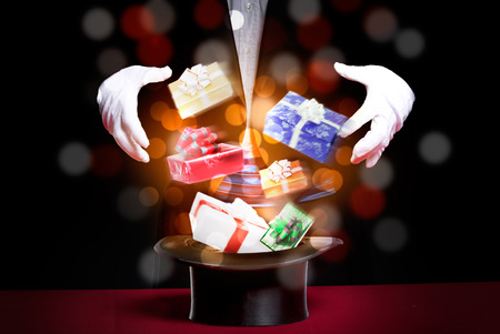 Magic of Christmas gifts, magician performs the trick with Christmas giftsの写真素材