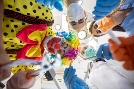 Bottom view of dental team working with funny clown