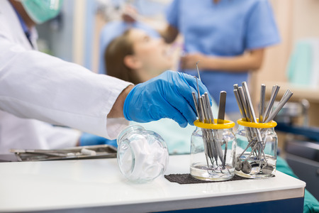Close up of hand taking dental instrumentsの写真素材