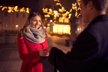 Happy young woman  receives a present from her boyfriend, present for Christmasの写真素材