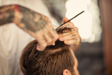 Haircut at barber shop with scissorsの写真素材