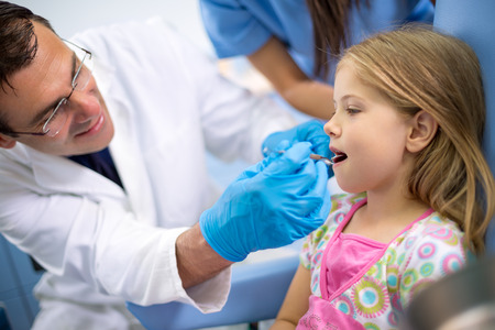 Dentist with young patient in dental chair are in ambulanceの写真素材