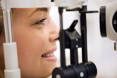 Close up of woman on ophthalmoscope eye deviceの写真素材