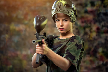 attractive female paintball targeting with gun