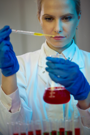 Female researcher carrying out research experiments in a chemistry labの写真素材