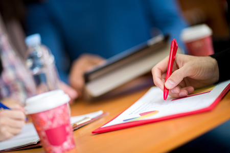 Close up view of hand drawing graph on the working tableの写真素材