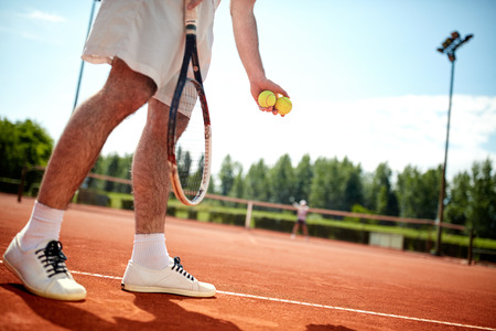 Close up of tennis player?s legs serving on tennis courtの写真素材
