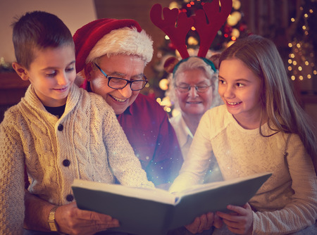grandparents and grandchildren reading magic xmas book