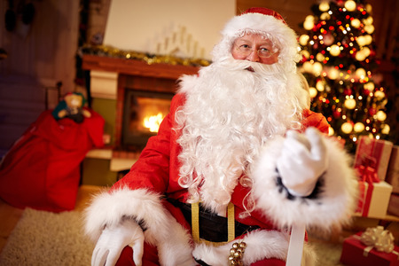 Santa Claus with little red box in hand, present for Christmasの写真素材