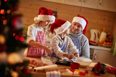children and father preparing Christmas cookies-Family timeの写真素材