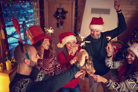 Cheerful friends toasting at New Year's midnightの写真素材