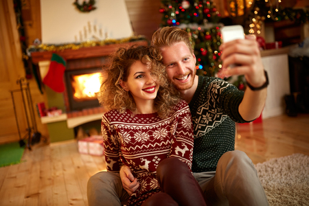 Male and female taking selfie for Christmasの写真素材