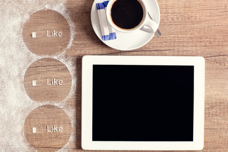 top view tablet and mug of coffee with sugar on wooden backgroundの写真素材