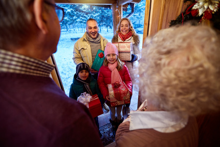 Family delivering presents at Christmas eveの写真素材