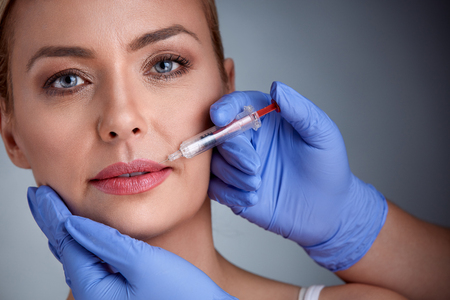 Woman having injection of  botox in lips,  beauty treatmentの写真素材