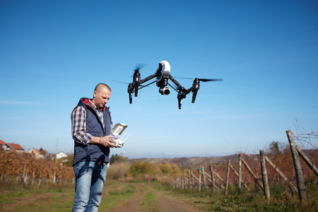 Man from ground remote control drone's flight